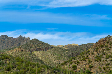 Fototapeta na wymiar Rolling hillsides in sabino national park in the cliffs and hills of tuscon arizona in the late afternoon shade with blue sky