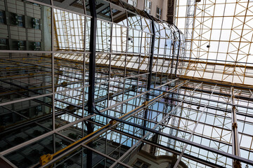 Fototapeta premium Iron construction with glass seen from below. Glass roof of a modern building