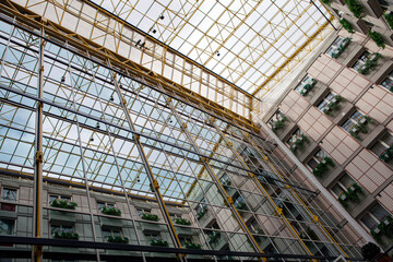 Obraz premium Iron construction with glass seen from below. Glass roof of a modern building
