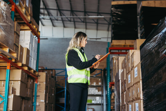 Female warehouse worker taking stock in a logistics centre