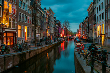Fototapeta na wymiar Canals of Amsterdam at night. Amsterdam is the capital and most populous city of the Netherlands