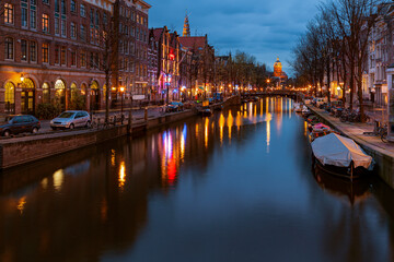 Fototapeta na wymiar Canals of Amsterdam at night. Amsterdam is the capital and most populous city of the Netherlands