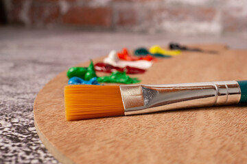 foreground brush with out-of-focus oil paint colors
