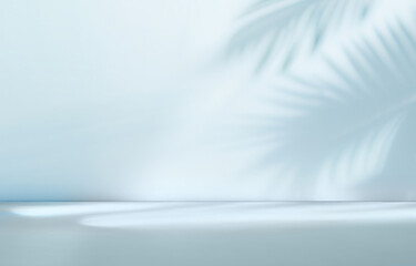 Blurred shadow from palm leaves on the light blue wall. Minimal abstract background for product...