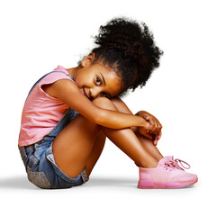 A mixed race young girl looking at the camera sitting and looking carefree in casual clothes...