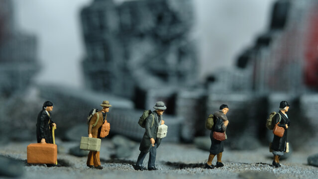 Miniature people toy figure photography. A group of refugee walking, moving in the middle of ruined destroyed building, demolish city.