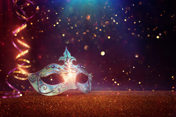 Image of elegant venetian mask over glitter background