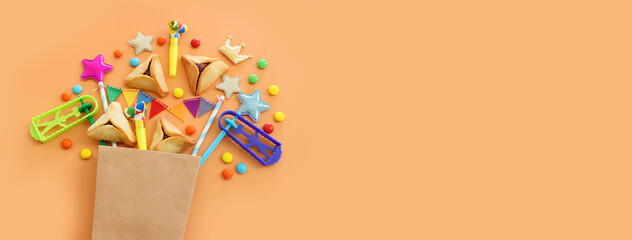 Purim celebration concept (jewish carnival holiday) over yellow background. Top view, flat lay