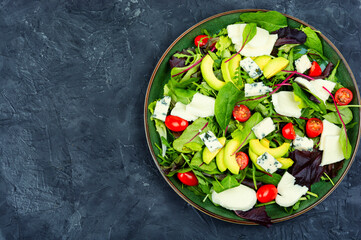Fresh vegetable salad with greens and mozzarella