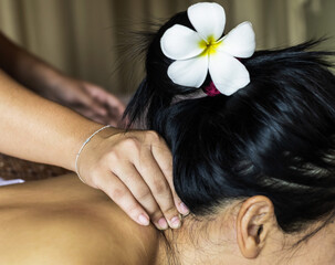 Fototapeta premium Massager doing Thai massage on neck for lady in massage and Spa shop