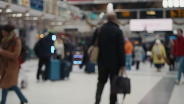 Blurred footage of unrecognizable people passing by on the station. Shot with Panasonic GH5   