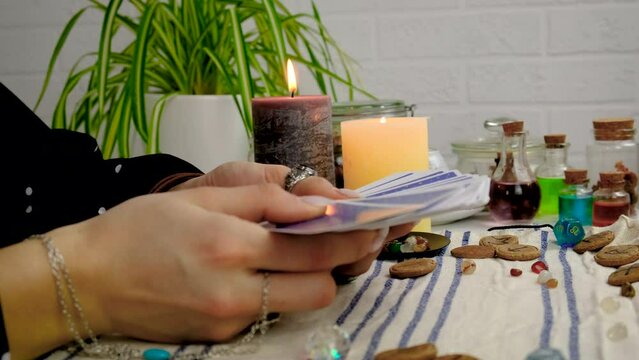 A fortune teller reads with tarot cards. Selective focus.
