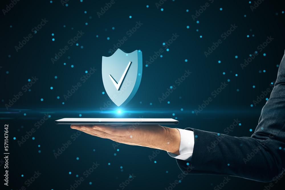 Poster Internet privacy and cyber protection concept with check mark on blue shield above digital tablet in man hand on abstract dark background with dots