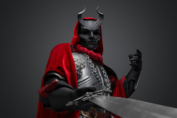 Portrait of evil knight with black mask pointing his sword to camera.