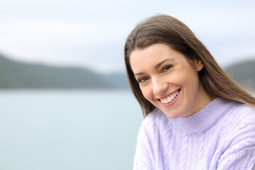 Happy teenager looking at camera in a lake