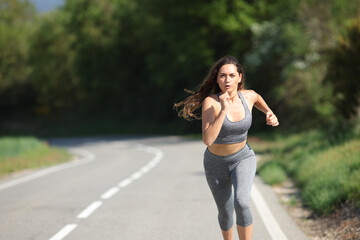 Woman running fast on a road