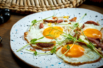 Classic breakfast - Fried egg with meat on a plate