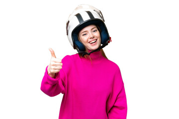Young pretty woman with a motorcycle helmet over isolated chroma key background with thumbs up because something good has happened