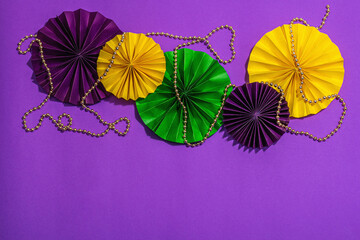 Festive Mardi Gras masquerade purple background. Fat Tuesday carnival, masks, beads, traditional decor