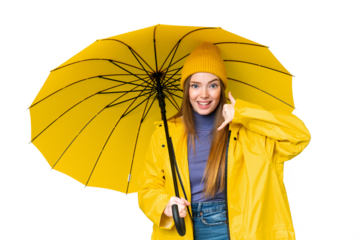 Young pretty woman with rainproof coat and umbrella over isolated chroma key background making phone gesture. Call me back sign