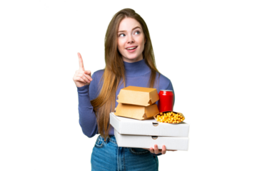 Young pretty woman holding pizzas and burgers over isolated chroma key background thinking an idea pointing the finger up