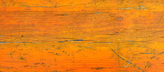 weathered wooden surface with chipped orange paint,old wood background,grunge background for design,