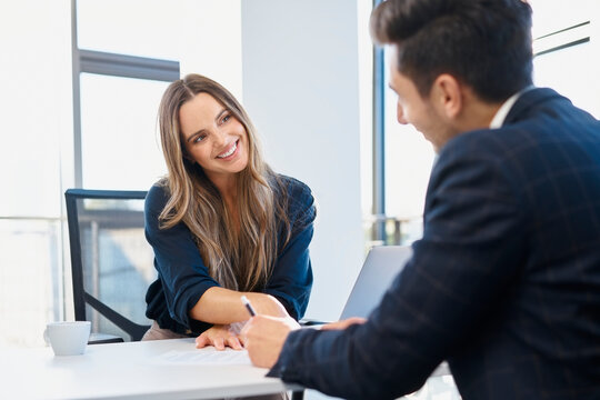 Happy businesswoman completing recruitment process with candidate at office