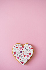 Gingerbread heart. Spring mood. Pastel colors. Delicious gingerbread on a light pink background. Sweet treats for lovers. Heart-shaped honey cake.