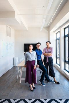 Portrait of confident male and female coworkers at board room in office