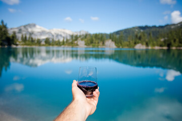 Enjoying a glass of red wine at the mountain lake.