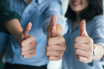 Closeup gruop of business people giving thumbs up