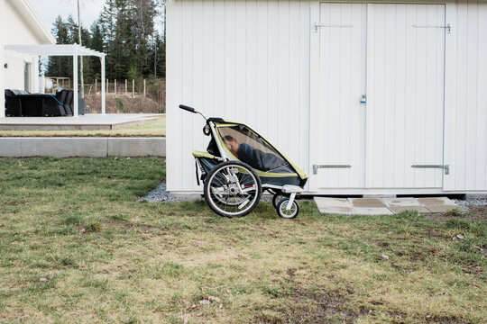 kid sleeping in a stroller outside in Sweden