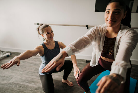 Female Personal Trainer Coaches Her Female Student How To Squat