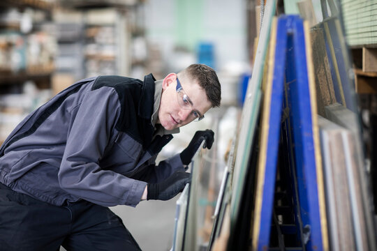 technician male working in a store checking a glass plate