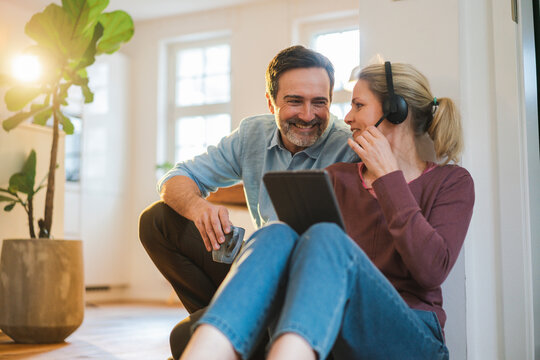 Smiling freelancer talking to man at home office