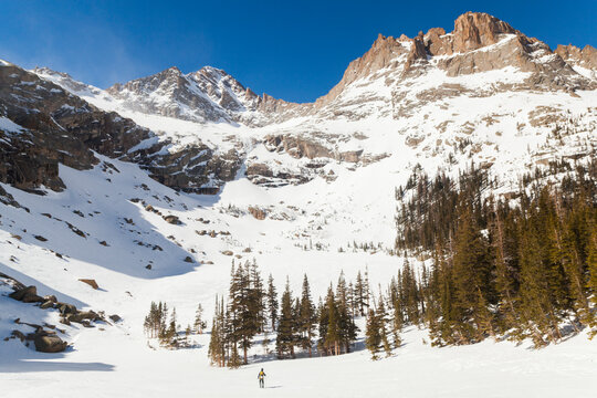 Hiker below high peaks at Black Lake, Rock Mountain National Park