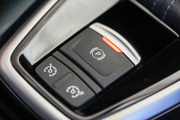 Obraz na płótnie Canvas Cruise control and parking brake buttons in a new luxury vehicle