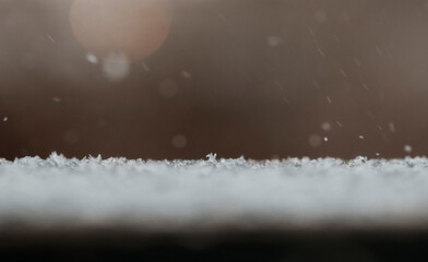 Snow flakes falling on the ground during a snow storm in winter