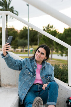 Young woman makes a selfie on a university campus