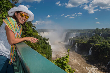woman overlooking the Iguacu waterfalls in Brazil