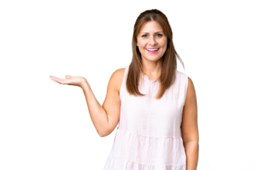 Middle age woman over isolated background holding copyspace imaginary on the palm to insert an ad