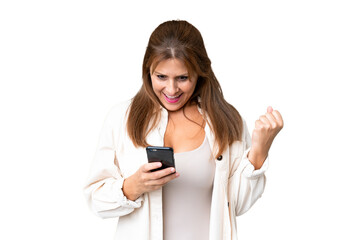 Fototapeta premium Middle age woman over isolated background surprised and sending a message