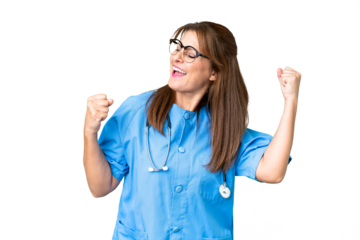 Middle age nurse woman over isolated background celebrating a victory