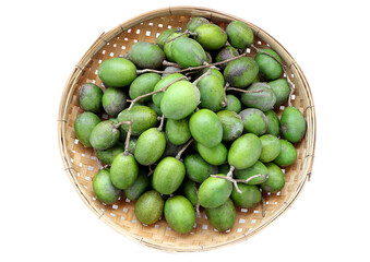 hog plums or Spondias mombin, Fresh ambarella, mombin hog plum fruit on bamboo colander on a white background.