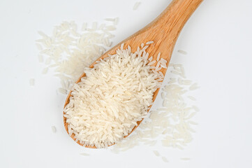 Rice food. Basmati rice in the wooden spoon, isolated on the white background