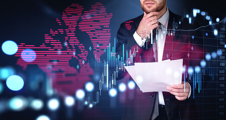 Businessman with papers, forex diagrams and candlesticks