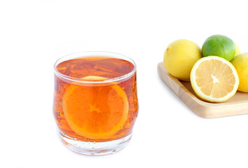 Glass of tasty cold ice tea and fresh lemon on white background. lemon against a background with copy space
