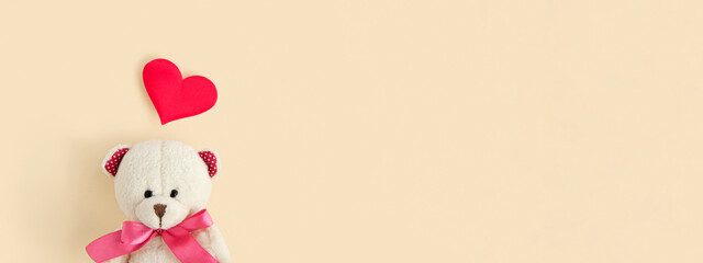 Valentine's Day. Love heart. Teddy Bear and Red Heart on Neutral Beige Color Pastel Background. Vintage Retro Romantic Style. Unusual Creative Greeting Card. Family, Wedding and Friendship. Top View