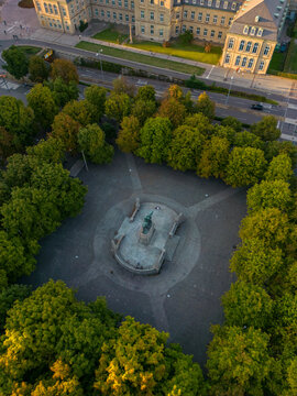 Drone view of King Karl's memorial statue amidst trees, Stuttgart, Germany