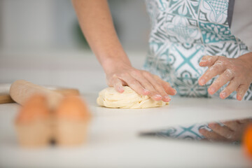 Obraz na płótnie Canvas a woman baking pies in her home kitchen